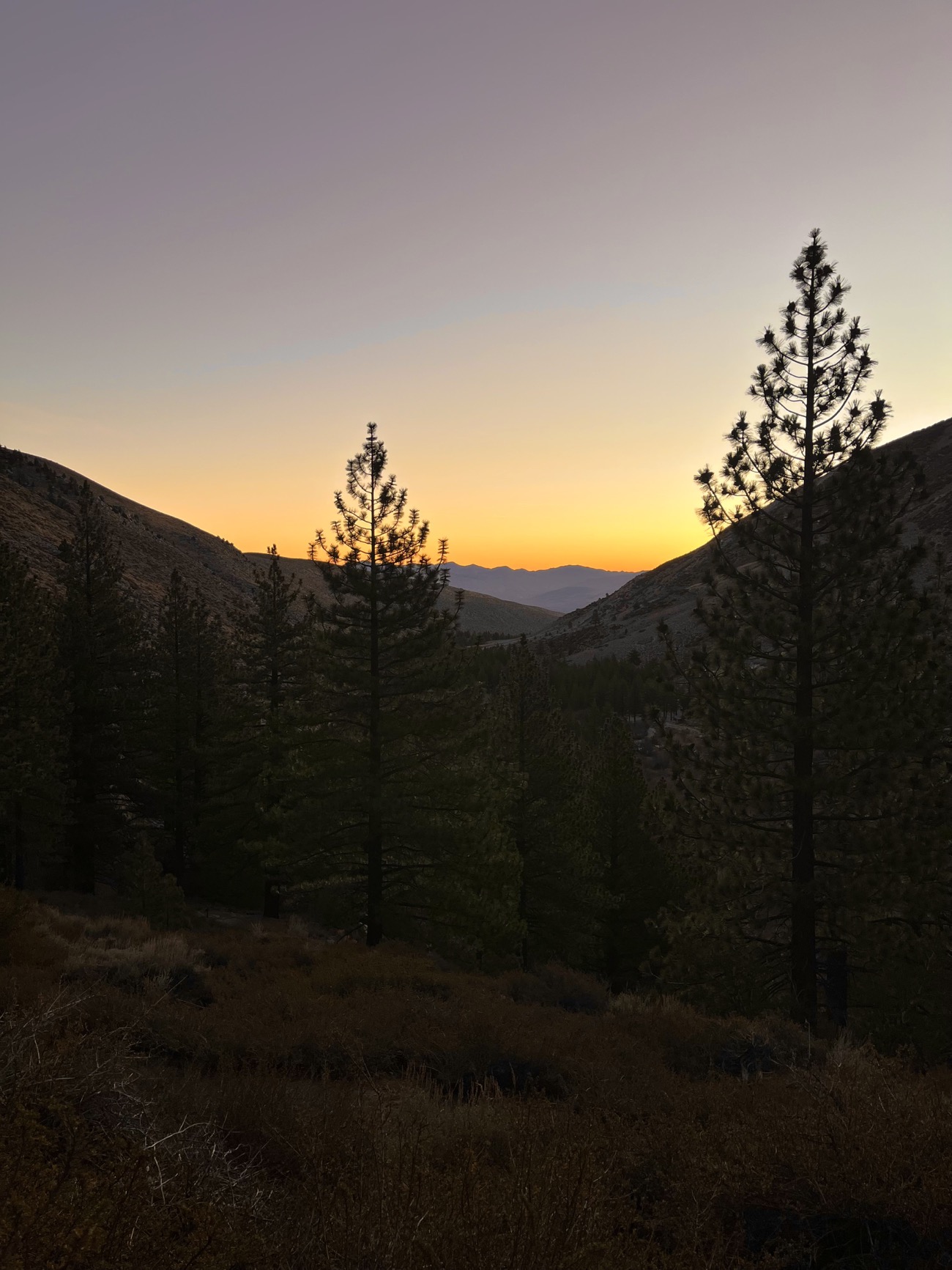 Sunrise glowing over distant mountains on the Big Pine Lakes Trail