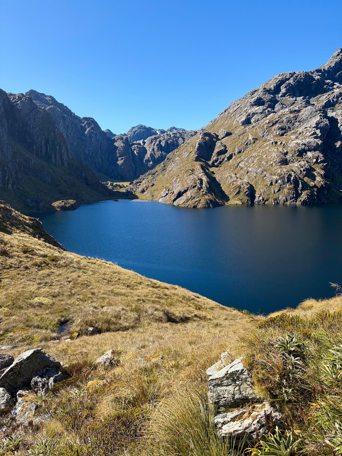 Lake Harris with surrounding mountains and distant waterfall
