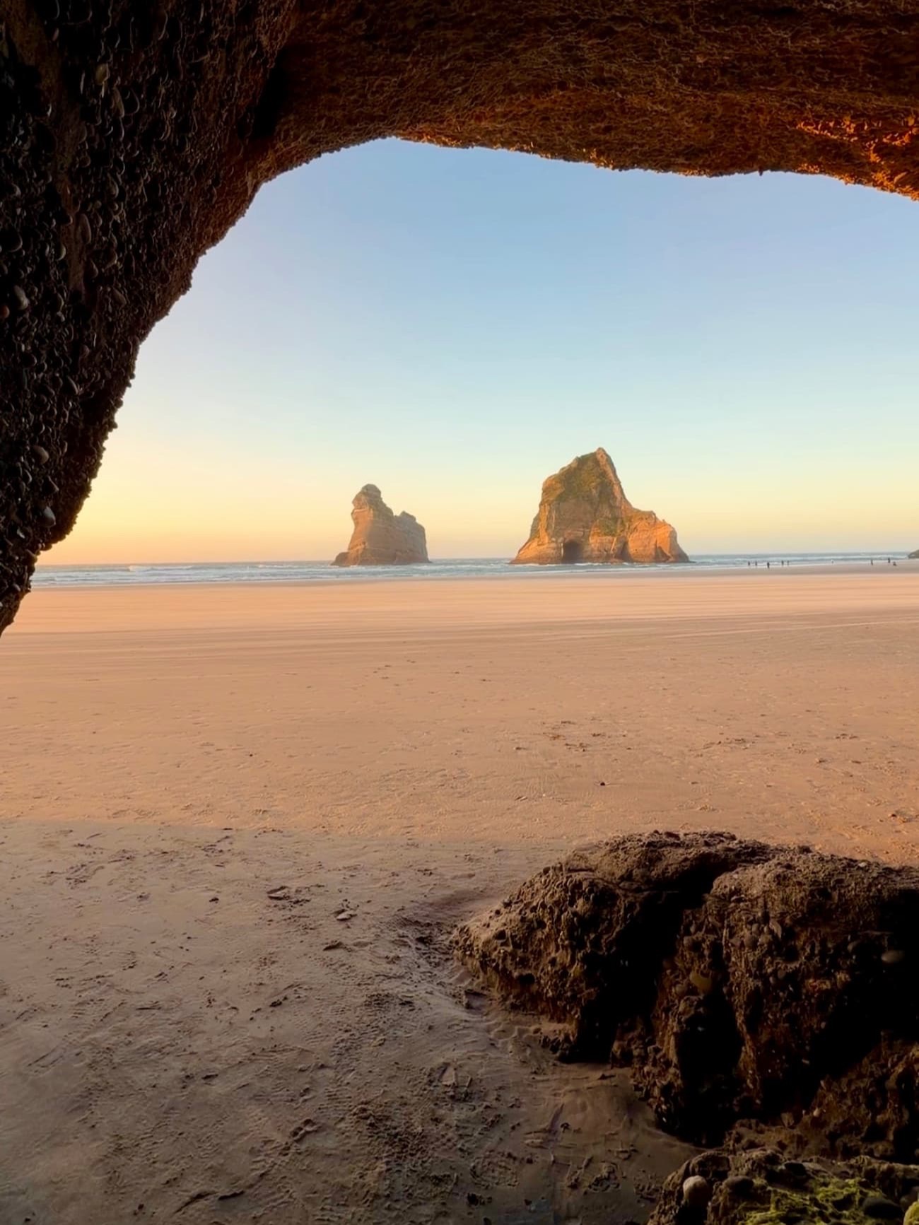 The sea cave arch at Wharariki Beach at sunset
